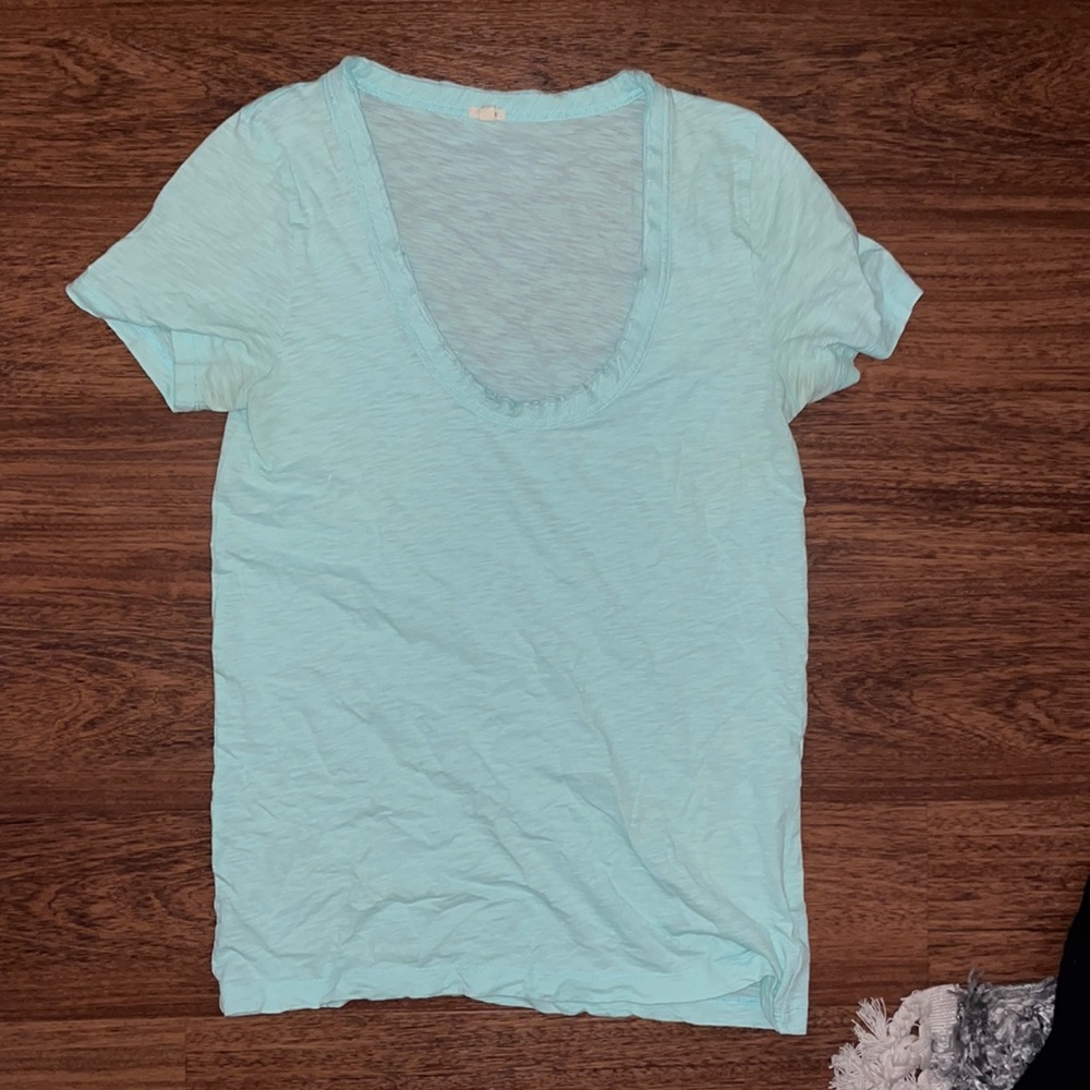 Scoop neck, light blue t shirt.